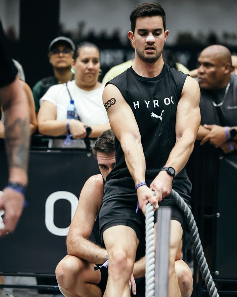 Athlete wearing a RestUp nasal strip on the HYROX sled pull