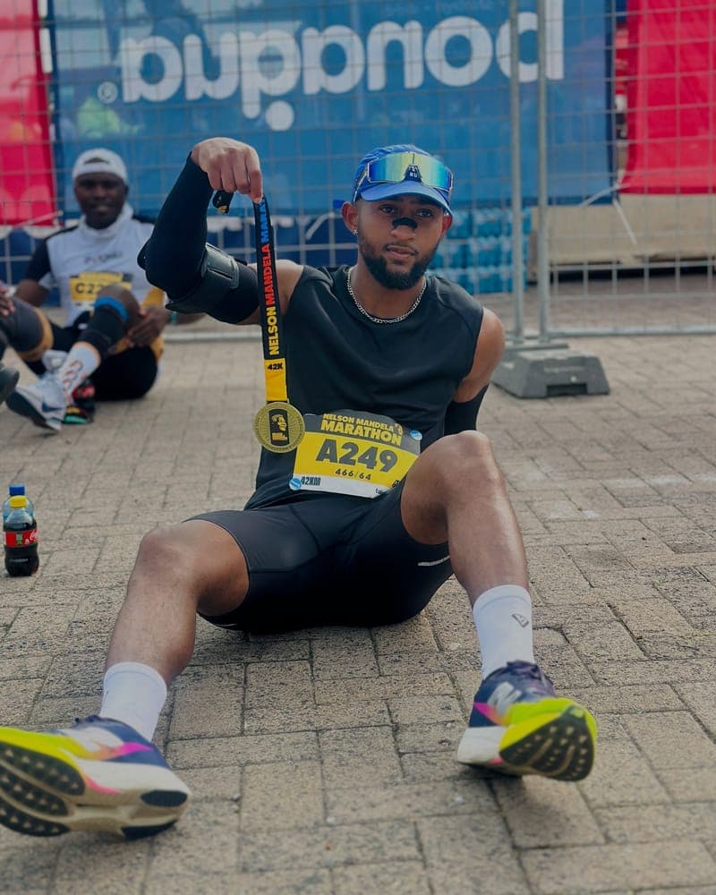 Runner with a finisher's medal wearing a RestUp nasal strip after the Nelson Mandela Marathon