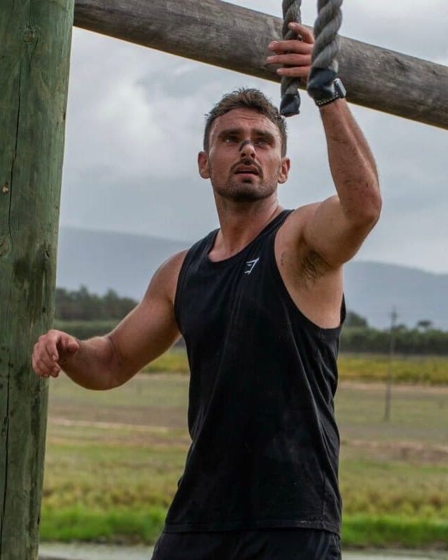 Athlete on a rope obstacle wearing a RestUp nasal strip