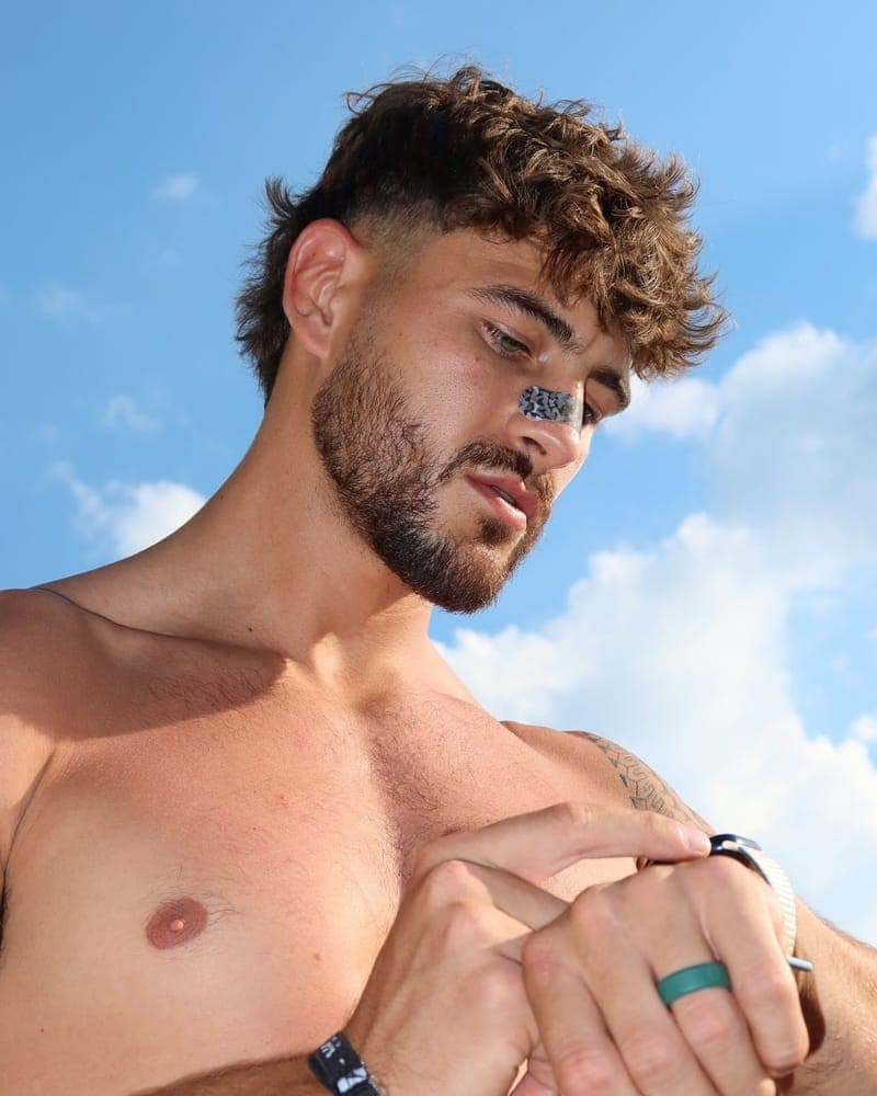 Man checking his watch while wearing a RestUp nasal strip